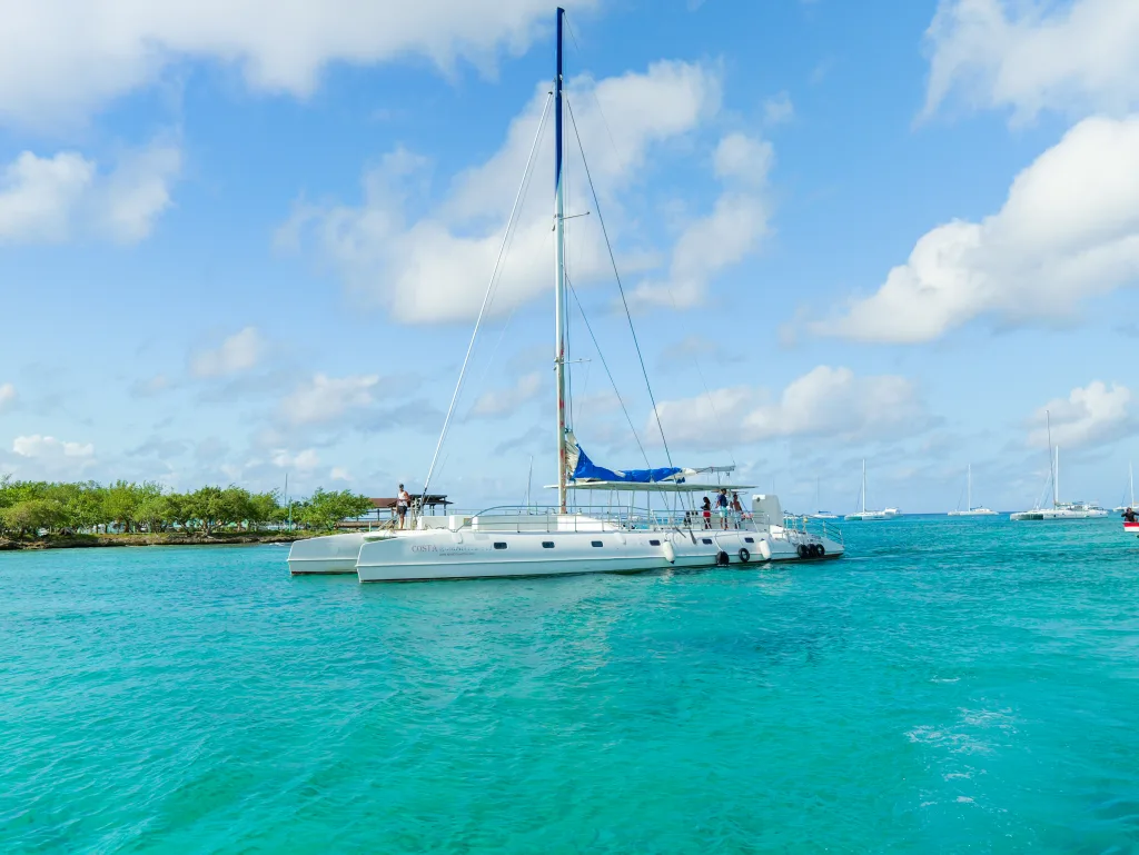 The deck of a private yacht with cushioned lounging area and sea view