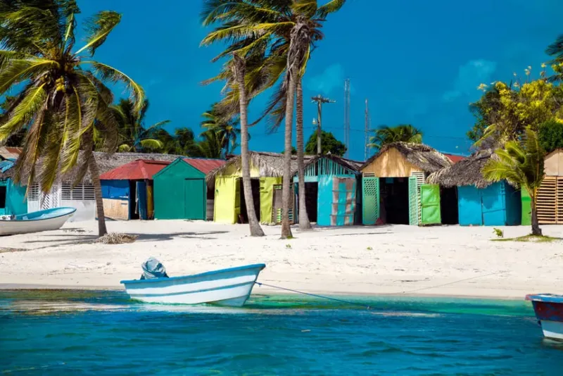 A brightly painted Dominican fishing boat pulled up on the sand at Mano Juan
