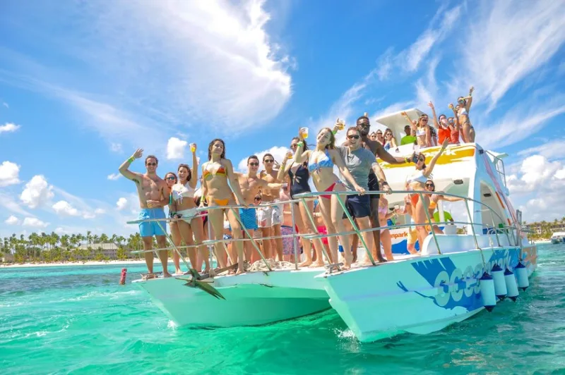 A catamaran sailboat with passengers heading toward Saona Island