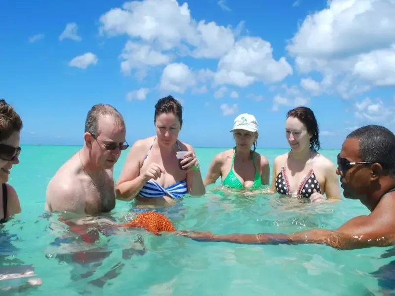Wide horizon view from the Natural Pool sandbar — turquoise water in every direction